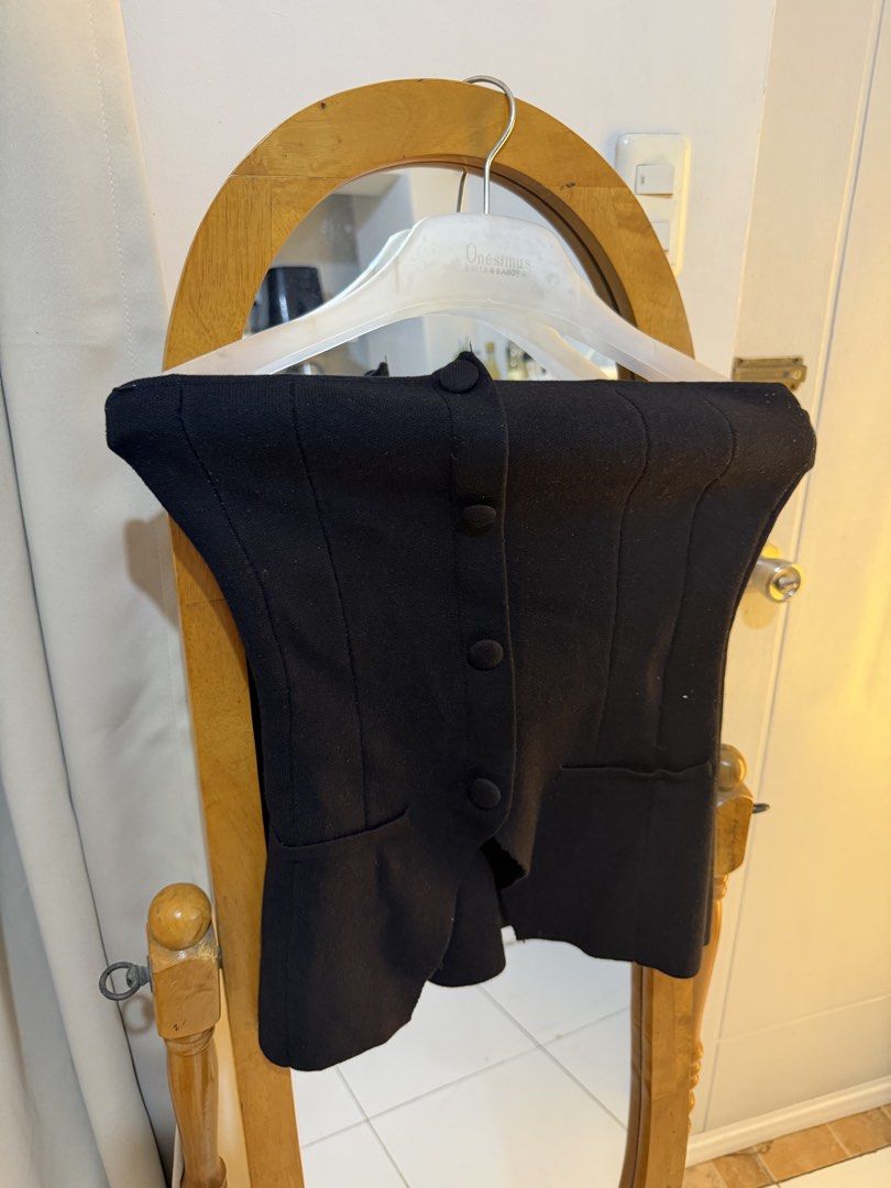 Black Button-Up Vest (Category: Others Tops) located in Mandaluyong City. Submitted by chocofudge__ (Listing ID 1461154444, Image 3). Description: - Black vest with button-up front - Structured fit with a cinched waist - Versatile for layering or wearing on its own - Perfect for night outs or smart casual occasions.