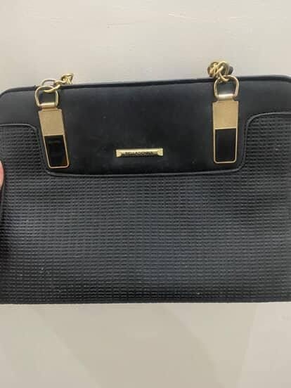 Black Handbag with Gold Hardware (Category: Luxury Bags & Wallets) located in Paranaque City. Submitted by Heyhey0125 (Listing ID 1461320355, Image 2). Description: - Stylish black handbag - Textured front panel - Elegant gold chain straps - Gold hardware details - Small metal logo plate accent - Immaculate interior - Versatile for everyday or evening wear.