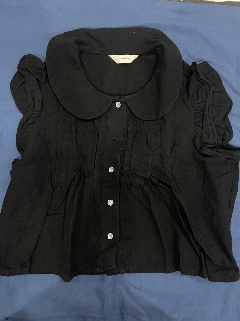 Black Peter Pan Collar Blouse with Ruffle Sleeves (Category: Blouses) located in Manila. Submitted by escherichiaa (Listing ID 1461294336, Image 1). Description: - Cute black blouse - Features a classic Peter Pan collar - Short sleeves with a ruffled detail - Button-up front for easy wear - Pintuck details on the bodice add a touch of elegance - Versatile for sweet or gothic looks - Pairs well with skirts or high-waisted pants.