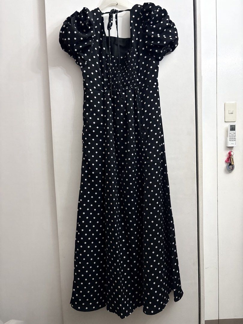 Black Polka Dot Puff Sleeve Maxi Dress (Category: Dresses) located in Quezon City. Submitted by thebutingthings (Listing ID 1461280163, Image 2). Description: - Elegant black maxi dress with classic white polka dots. - Stylish puff sleeves add a touch of flair. - Adjustable tie-back detail at the neckline for a customized fit. - Flattering smocked bodice ensures comfort and a great silhouette. - Versatile piece: dress it down for casual days or u