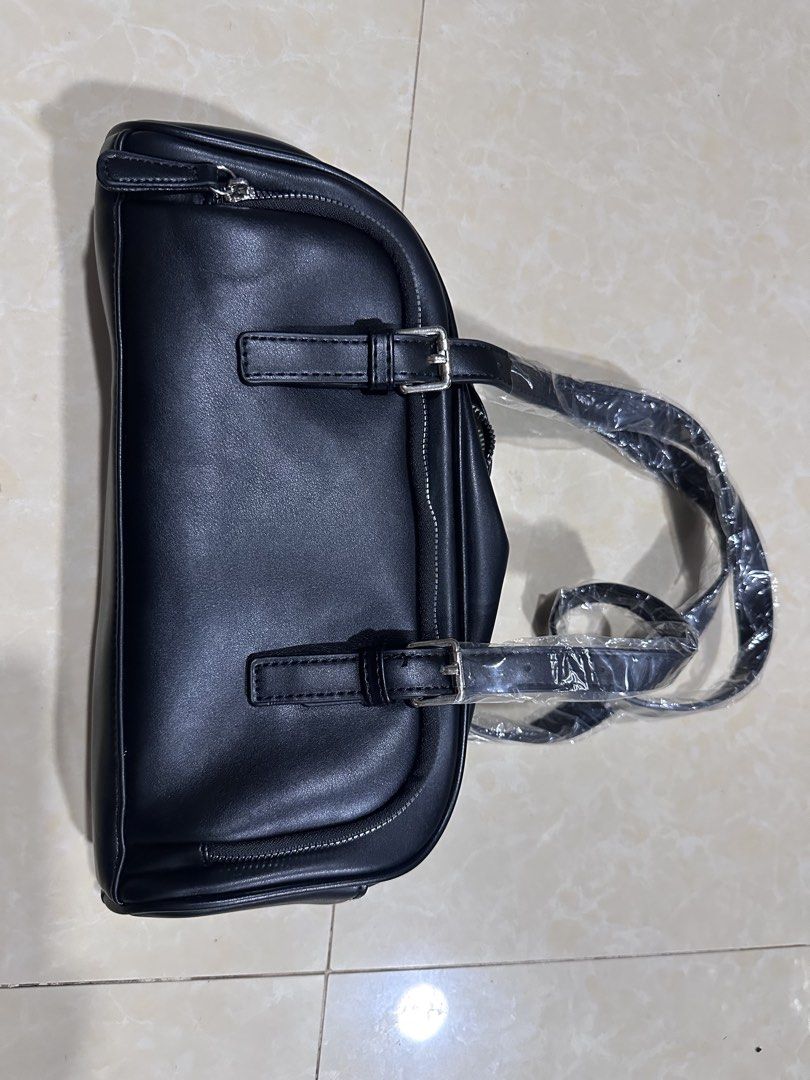 Black Shoulder Bag with Silver Hardware (Category: Luxury Bags & Wallets) located in Mandaluyong City. Submitted by greenapple14 (Listing ID 1461258788, Image 2). Description: - Classic black shoulder bag - Made from durable faux leather - Secure zip closure - Stylish silver hardware details - Two comfortable carrying straps - Spacious interior with an internal zip pocket - Ideal for everyday wear and tear.