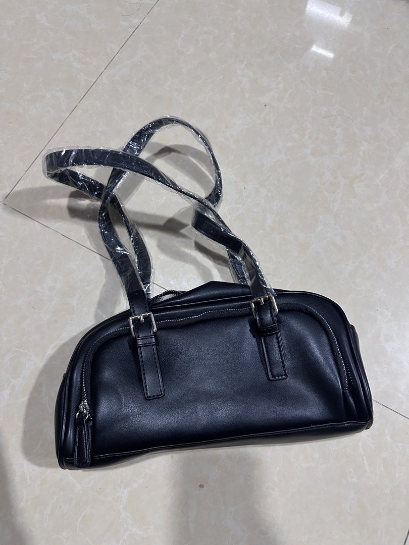 Black Shoulder Bag with Silver Hardware (Category: Luxury Bags & Wallets) located in Mandaluyong City. Submitted by greenapple14 (Listing ID 1461258788, Image 1). Description: - Classic black shoulder bag - Made from durable faux leather - Secure zip closure - Stylish silver hardware details - Two comfortable carrying straps - Spacious interior with an internal zip pocket - Ideal for everyday wear and tear.