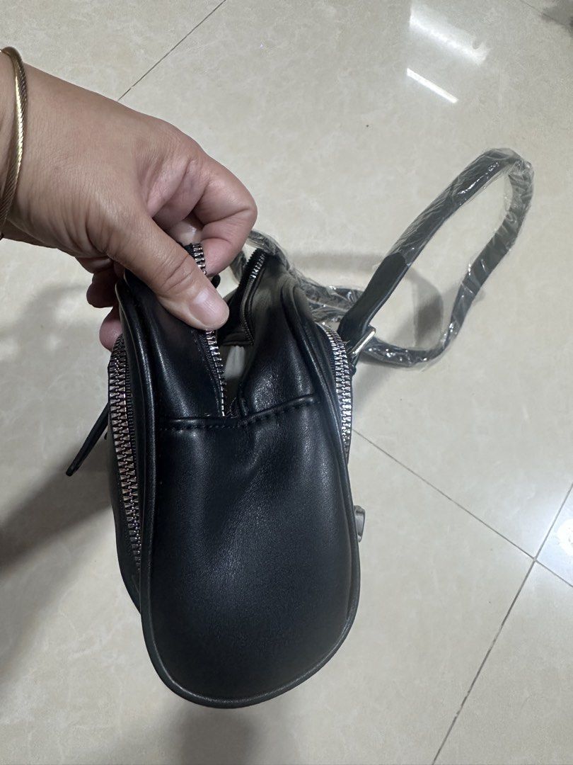 Black Shoulder Bag with Silver Hardware (Category: Luxury Bags & Wallets) located in Mandaluyong City. Submitted by greenapple14 (Listing ID 1461258788, Image 3). Description: - Classic black shoulder bag - Made from durable faux leather - Secure zip closure - Stylish silver hardware details - Two comfortable carrying straps - Spacious interior with an internal zip pocket - Ideal for everyday wear and tear.