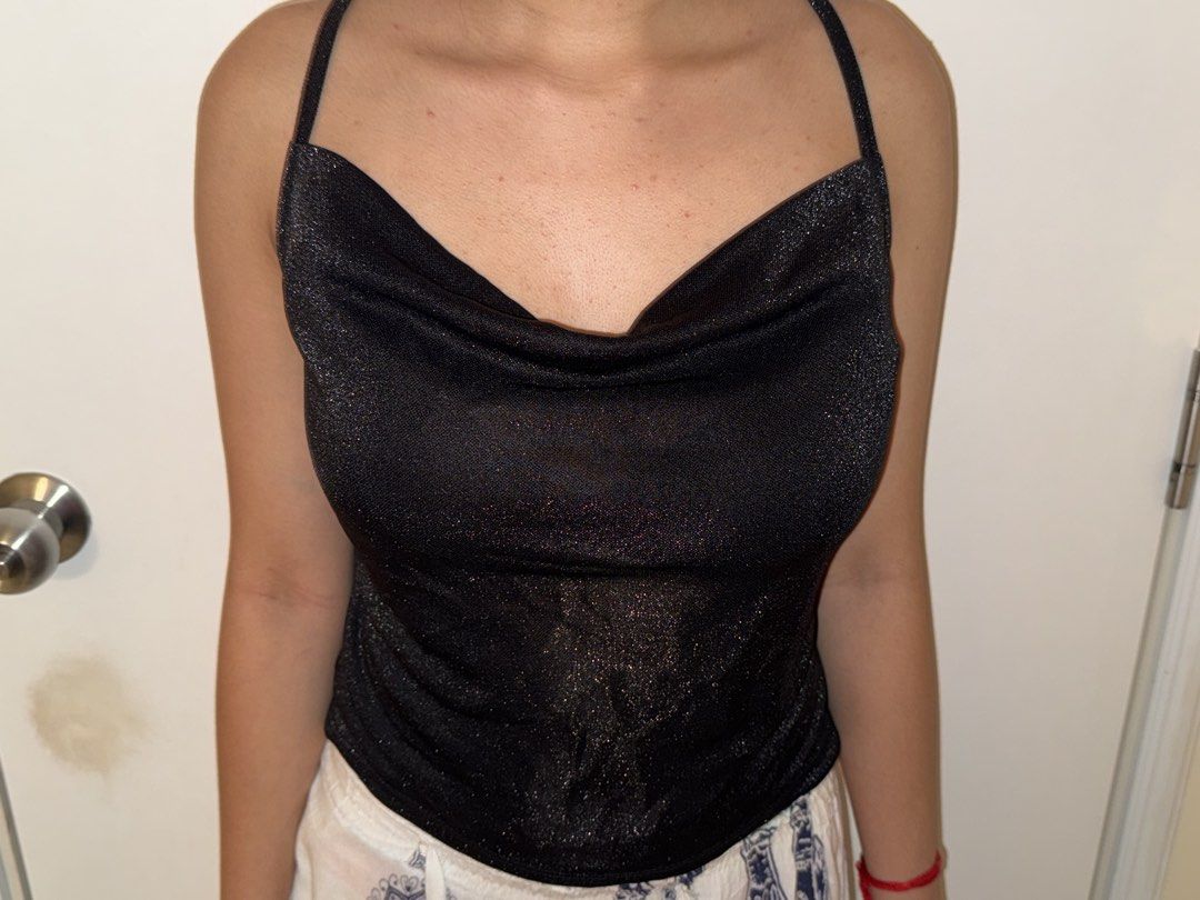 Black Sparkly Cowl Neck Cami Top (Category: Sleeveless) located in Manila. Submitted by cooldragon_2d8241 (Listing ID 1461261103, Image 3). Description: - MAKATI AREA SMALL Sparkly black cami top - Elegant cowl neckline - Thin spaghetti straps - Subtle shimmer fabric - Versatile: dress up or down - Ideal for nights out or special occasions - Comfortable and stylish.