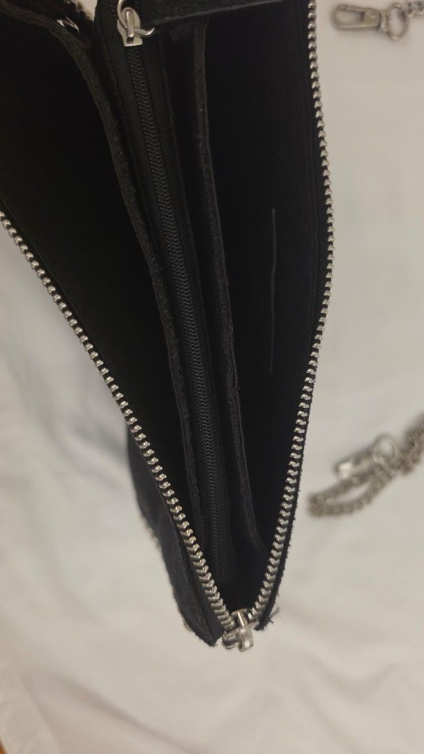 Black Suede Studded Clutch Bag with Silver Chain Strap (Category: Clutches) located in Mandaluyong City. Submitted by mysharecloset (Listing ID 1461304960, Image 2). Description: - Black suede clutch bag - Studded detail around the edges - Detachable silver chain strap - Secure zipper closure - Multiple interior compartments - Interior zippered pocket - Ideal for nights out and events.