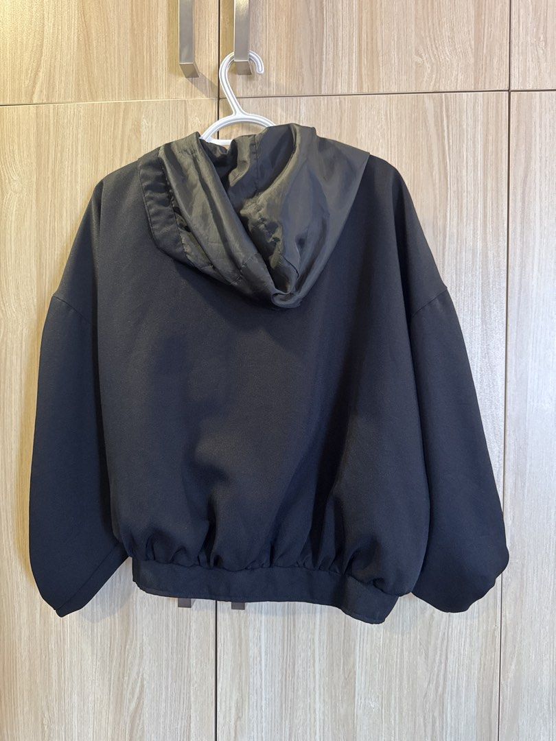 Black Zip-Up Bomber Jacket with Drawstring Hood (Category: Coats, Jackets and Outerwear) located in Bacolod City. Submitted by bellabianca_closet (Listing ID 1461116898, Image 2). Description: Best fit L-XL Oversized - Lightweight black bomber jacket - Zip-up front closure - Drawstring hood for adjustable coverage - Elasticated cuffs and hem for a snug fit - Two convenient side pockets - Ideal for casual outfits or as a layering piece.