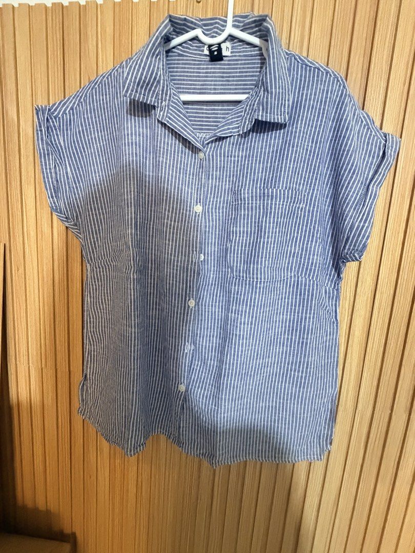 Blue and White Striped Button-Up Shirt (Category: Shirts) located in Makati City. Submitted by ziagabrielle (Listing ID 1461141161, Image 2). Description: - Casual short-sleeved shirt - Blue and white vertical stripes - Chest pocket - Button-up front - Cuffed sleeves - Comfortable for everyday wear - Easy to style with jeans or shorts -W22xL26.