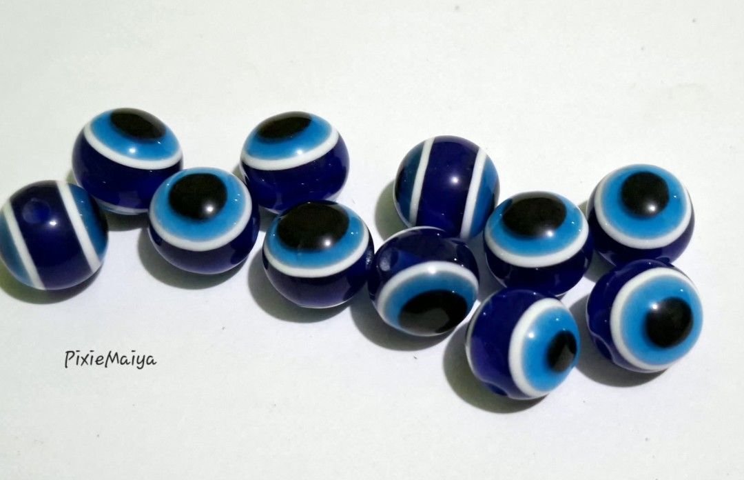 Blue Evil Eye Beads for Jewelry Making (Category: Craft Supplies & Tools) located in Valenzuela. Submitted by pixieworks64309 (Listing ID 1461319345, Image 1). Description: - Set of 10 blue evil eye beads - Ideal for DIY jewelry projects (bracelets, necklaces) - Features classic evil eye design for protection - Beads have a hole for easy stringing.