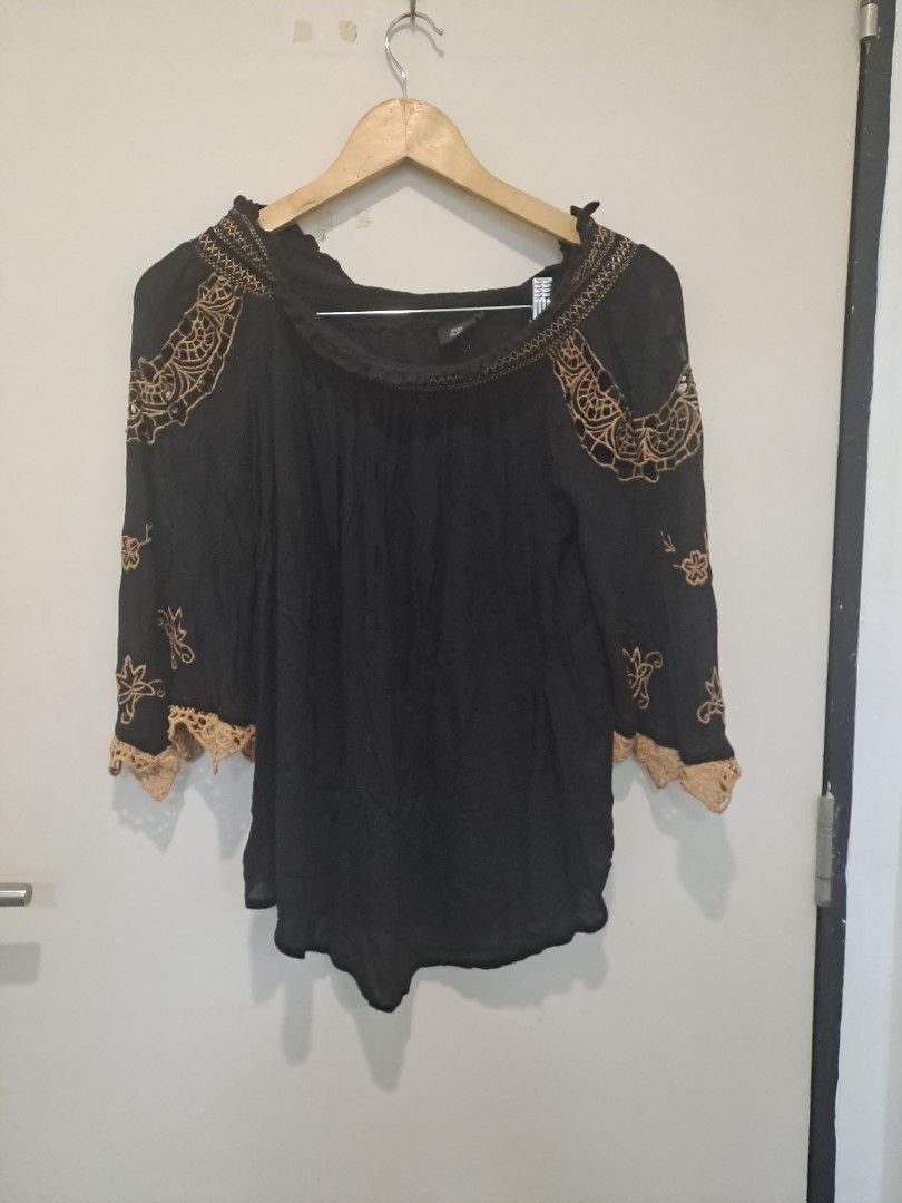 Bohemian off shoulder (Category: Longsleeves) located in Manila. Submitted by joanbalde39643 (Listing ID 1461235445, Image 1). Description: This River Island off-shoulder peasant blouse features a lightweight black cotton fabric accented with intricate, contrast tan crochet panels and floral embroidery across the shoulders and sleeves. It is designed with elasticated bardot trims and flared, scalloped cuffs for a relaxed bohemian silhouette..