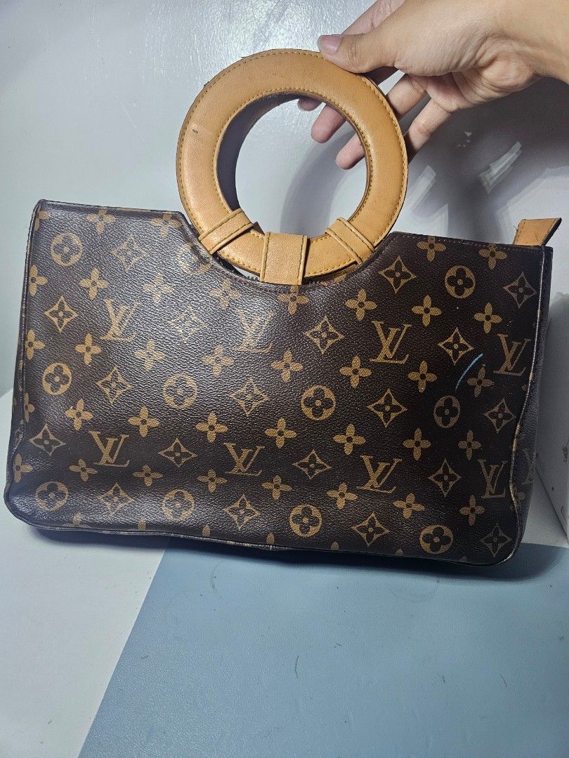 Brown monogram handbag with Circular Handle (Category: Luxury Bags & Wallets) located in Marikina City. Submitted by lalala60325 (Listing ID 1461292778, Image 2). Description: Brown monogram handbag minimal marks on handle and leather but still in good Condition Can send Vid for bag Condition.