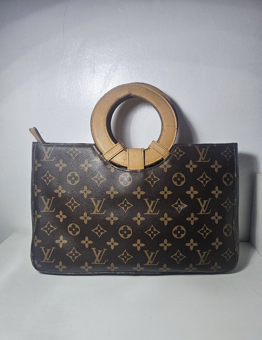 Brown monogram handbag with Circular Handle (Category: Luxury Bags & Wallets) located in Marikina City. Submitted by lalala60325 (Listing ID 1461292778, Image 1). Description: Brown monogram handbag minimal marks on handle and leather but still in good Condition Can send Vid for bag Condition.