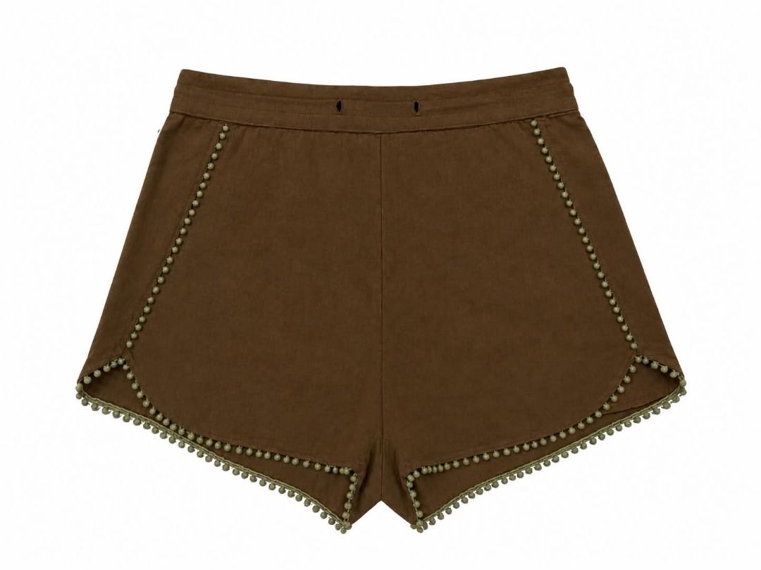 Brown Shorts#81 (Category: Shorts) located in Caloocan City. Submitted by outfitloop (Listing ID 1461141776, Image 2). Description: - Unique pom pom trim along edges - Features a two-button waistband - Effortlessly pairs with simple tops IMPORTANT: • 1st photo is an AI styling/model preview for reference on how the item may look when worn. • Please refer to the actual photos for the item’s true appearance and condition. • Color may slightly vary 