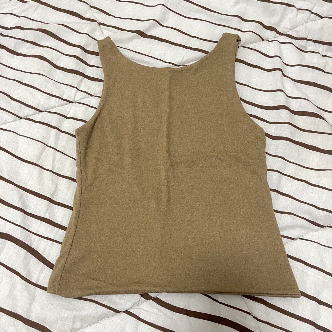 Brown Sleeveless Tank Top (Category: Sleeveless) located in Manila. Submitted by ukhy_shop (Listing ID 1461143742, Image 1). Description: - Basic brown tank top - Sleeveless design - Cotton material - Great fit: S 🛒— ₱80 ONLY dm to avail ‼️.