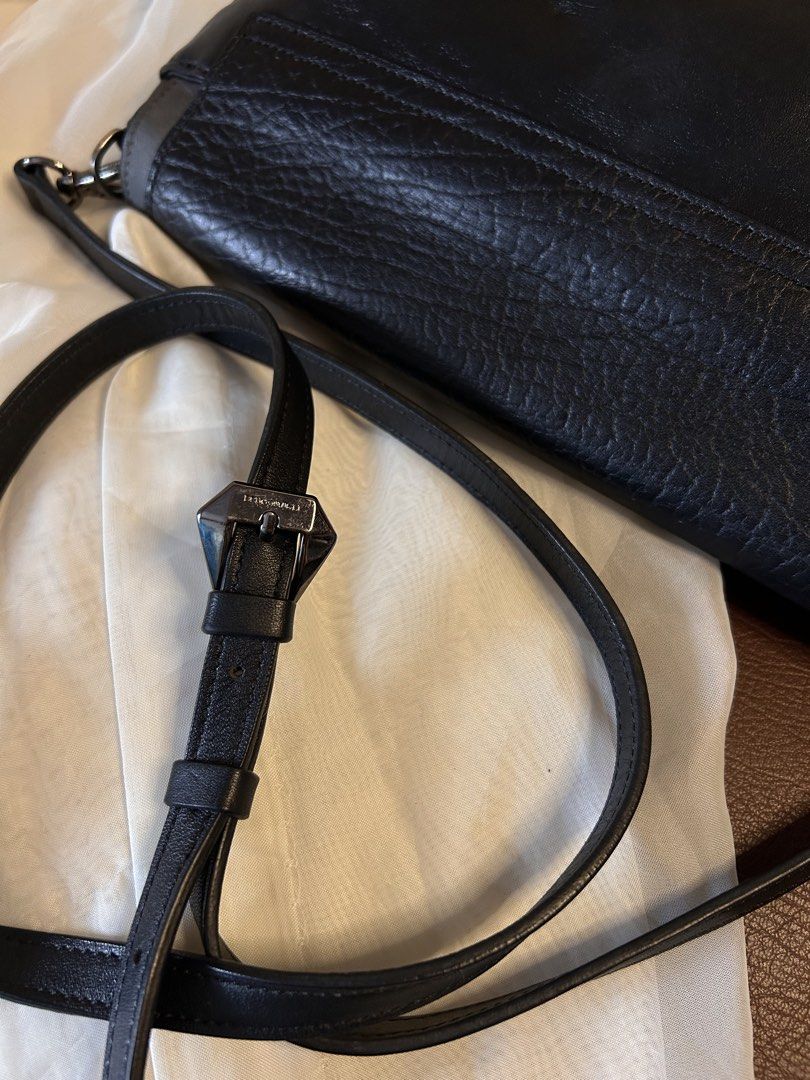 BRUNO MAGLI SLINGBAG (Category: Cross-body Bags) located in Baguio. Submitted by chmlnstudio (Listing ID 1461297925, Image 3). Description: Product Details ✦ Brand: Bruno Magli ✦ Color & Texture: Black pebbled leather flap with smooth charcoal/dark gray accents Hardware & Features: ✦ Dark gunmetal-tone hardware with engraved Bruno Magli branding on the front plate, strap buckle, and clips ✦ Flap closure with secure magnetic snap button ✦ Detachab