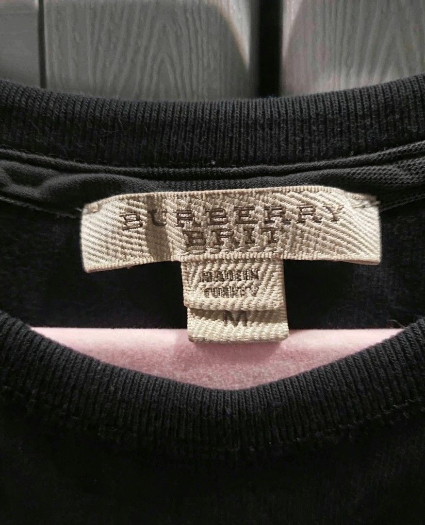 Burberry Brit Black Short Sleeve Tee (Category: Luxury Apparel) located in Naga. Submitted by bitchesabarbie (Listing ID 1461229558, Image 2). Description: ✅ Brand: Burberry ✅ Material: 100% Premium Cotton — soft, smooth, breathable & comfortable all day ✅ Color: Timeless solid black ✅ Design: Simple round neck, short sleeves, signature subtle trim at cuffs & inner neck — minimalist, elegant, very versatile ✅ Fit: Relaxed cut — easy to match with