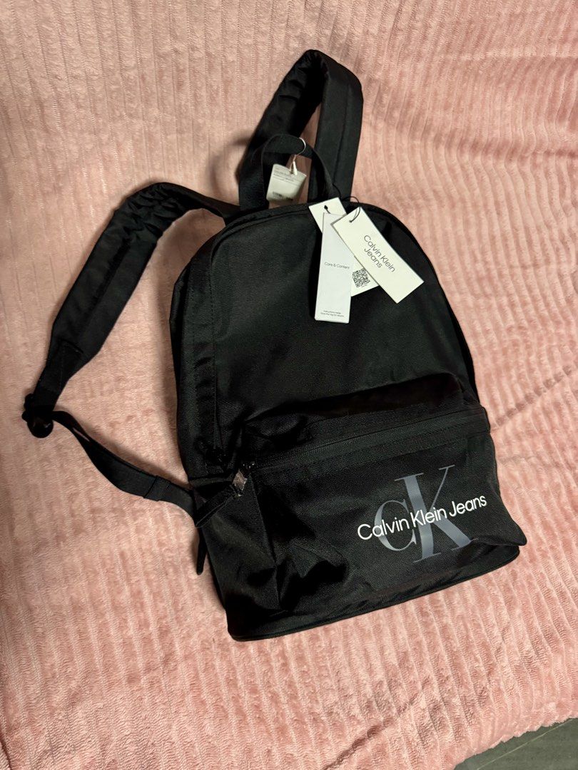 CALVIN KLEIN JEANS BACKPACK (Category: Laptop Bags & Sleeves) located in Taguig. Submitted by shopbyluna18 (Listing ID 1461317020, Image 1). Description: Brand New with Tags ✨ Original Calvin Klein Jeans ✨ Classic black design — easy to match with any outfit ✨ Spacious main compartment ✨ Front zip pocket for quick-access essentials ✨ Comfortable adjustable shoulder straps ✨ Perfect for school, work, travel & everyday use .
