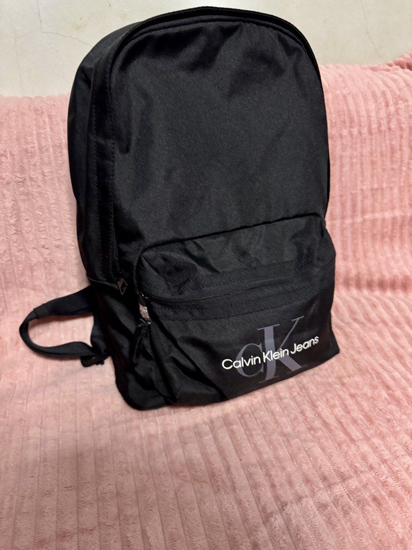 CALVIN KLEIN JEANS BACKPACK (Category: Laptop Bags & Sleeves) located in Taguig. Submitted by shopbyluna18 (Listing ID 1461317020, Image 2). Description: Brand New with Tags ✨ Original Calvin Klein Jeans ✨ Classic black design — easy to match with any outfit ✨ Spacious main compartment ✨ Front zip pocket for quick-access essentials ✨ Comfortable adjustable shoulder straps ✨ Perfect for school, work, travel & everyday use .