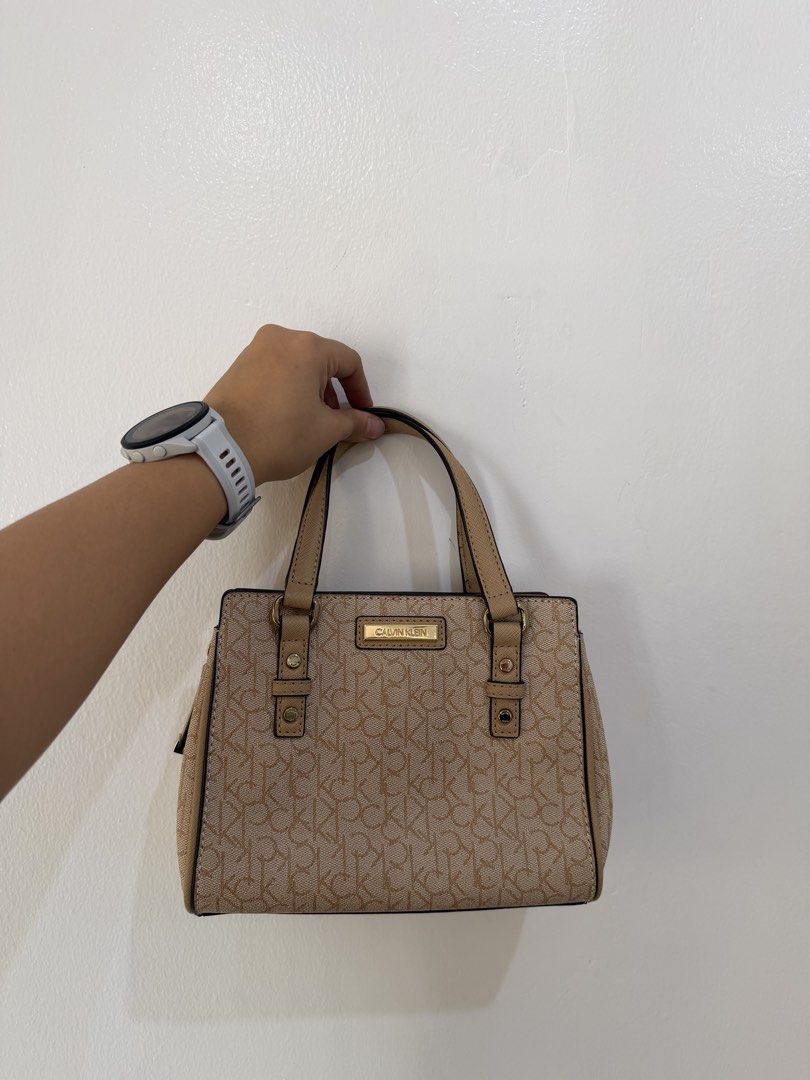 Calvin Klein Mini Sling Bag (Category: Luxury Bags & Wallets) located in Manila. Submitted by escarchame98247 (Listing ID 1461161989, Image 1). Description: - Authentic Calvin Klein satchel bag - Classic CK monogram print - Chic tan and brown colorway - Versatile with top handles and detachable strap - Elegant gold hardware accents - Ideal for everyday style and practicality.