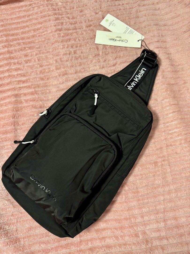 CALVIN KLEIN SLING BAG (Category: Sling Bags) located in Taguig. Submitted by shopbyluna18 (Listing ID 1461316345, Image 1). Description: CALVIN KLEIN SLING BAG — FOR SALE! 🖤 ✨ Brand New / With Tags ✨ Authentic Calvin Klein Sport ✨ Sleek & minimalist black design ✨ Multiple compartments for easy organization ✨ Adjustable strap ✨ Perfect for everyday use, travel, errands & OOTD 🤍 ✨ Lightweight but spacious enough for your essentials 📦 Condition