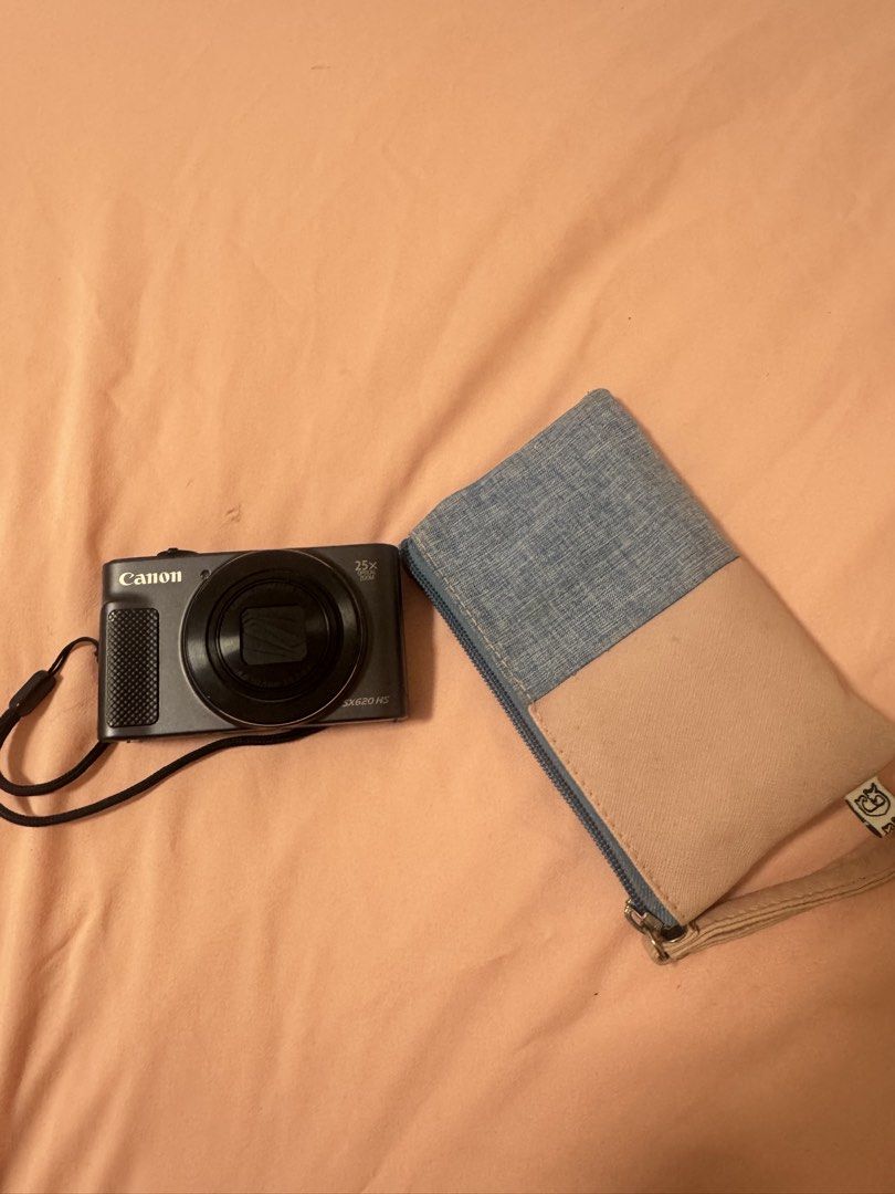 Canon SX620 HS 25x Optical Zoom Digital Camera (Category: Cameras) located in Quezon City. Submitted by itspaulinedc (Listing ID 1461260953, Image 2). Description: Barely used and in good condition. Fully working, no issues. Lens, screen, and buttons are all fine. Comes with built-in strap (as shown). Comes with original charger. Great for travel, everyday photos, or vlogging. Comes with screen protector. - Canon SX620 HS Digital Camera - 25x Opt