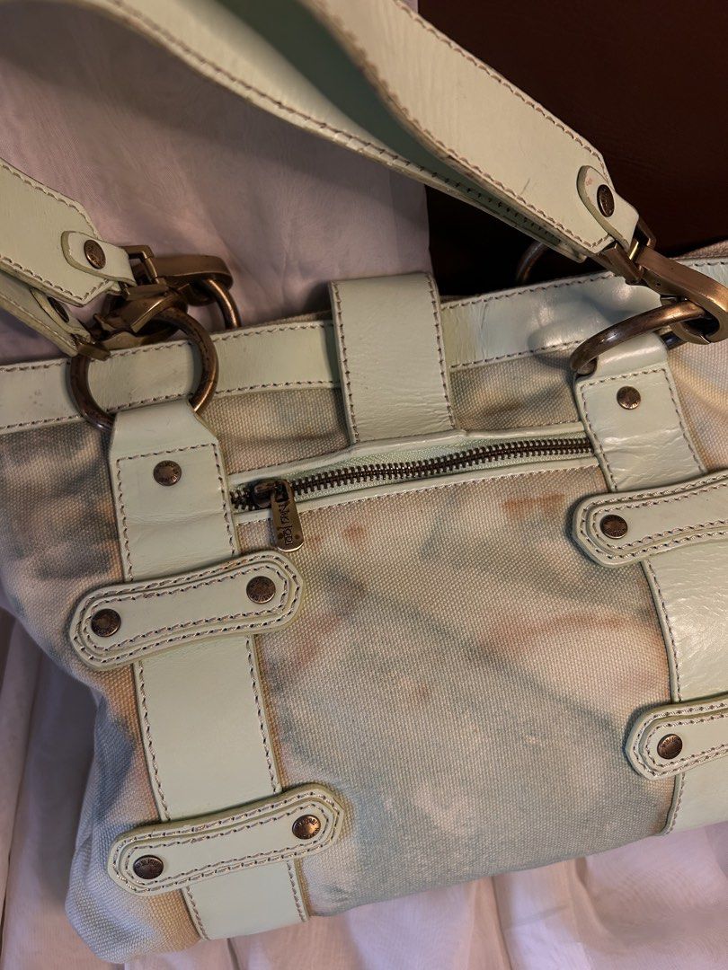 CANVAS NIKI JODI SHOULDER BAG (Category: Shoulder Bags) located in Baguio. Submitted by chmlnstudio (Listing ID 1461189439, Image 3). Description: Product Details ✦ Brand: Niki Jodi ✦ Style: Canvas & Leather Accent Tote / Shoulder Bag ✦ Colorway: Cream canvas base with mint green leather trim — length: 18” — width: 14” Features: ⟢ Front flap closure with antique brass dog-clip detail and signature enamel ribbon logo charm ⟢ Dual shoulder straps +