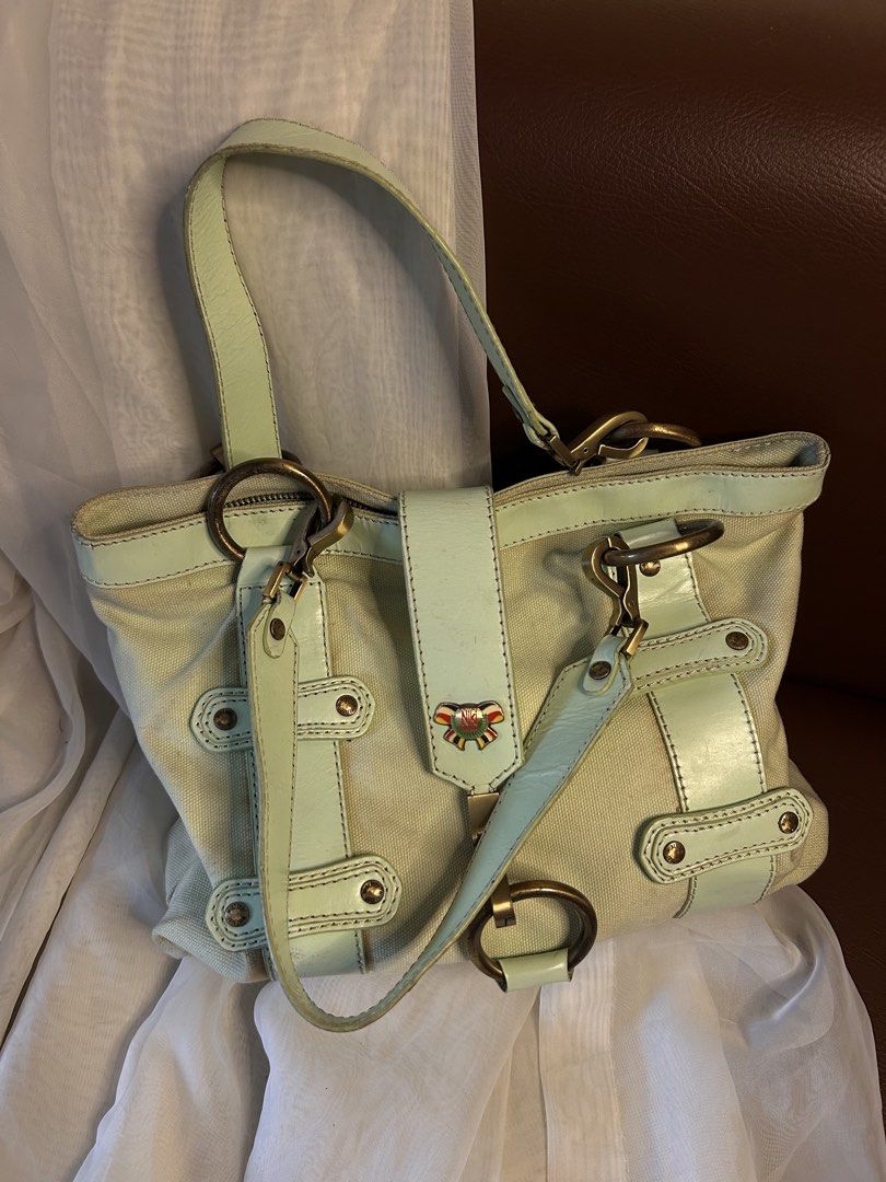 CANVAS NIKI JODI SHOULDER BAG (Category: Shoulder Bags) located in Baguio. Submitted by chmlnstudio (Listing ID 1461189439, Image 1). Description: Product Details ✦ Brand: Niki Jodi ✦ Style: Canvas & Leather Accent Tote / Shoulder Bag ✦ Colorway: Cream canvas base with mint green leather trim — length: 18” — width: 14” Features: ⟢ Front flap closure with antique brass dog-clip detail and signature enamel ribbon logo charm ⟢ Dual shoulder straps +