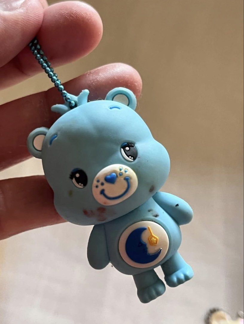 Carebear bag charm Blue #1 AS IS (Category: Character Goods) located in Paranaque City. Submitted by bonsaiart (Listing ID 1461274844, Image 1). Description: Pre owned Minor flaw : red marker stain as is 185+sf Payment via GCASH or paymaya No to meetup No to cop / cod Shipping via j&t only No breaking of set or bundle.