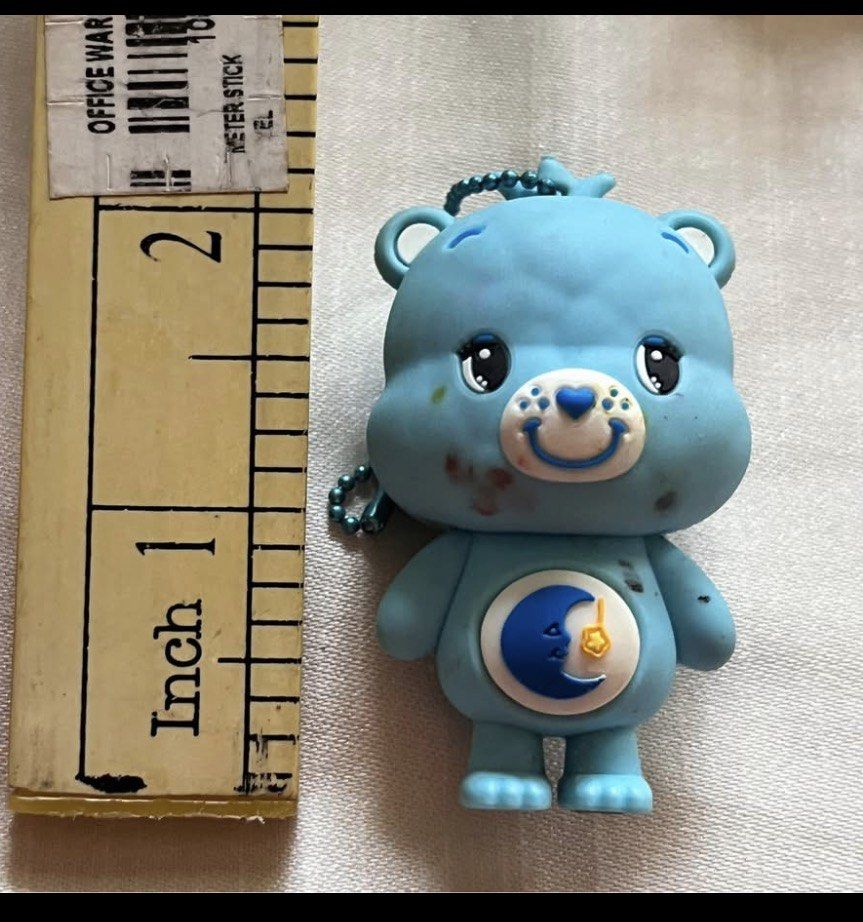Carebear bag charm Blue #1 AS IS (Category: Character Goods) located in Paranaque City. Submitted by bonsaiart (Listing ID 1461274844, Image 2). Description: Pre owned Minor flaw : red marker stain as is 185+sf Payment via GCASH or paymaya No to meetup No to cop / cod Shipping via j&t only No breaking of set or bundle.