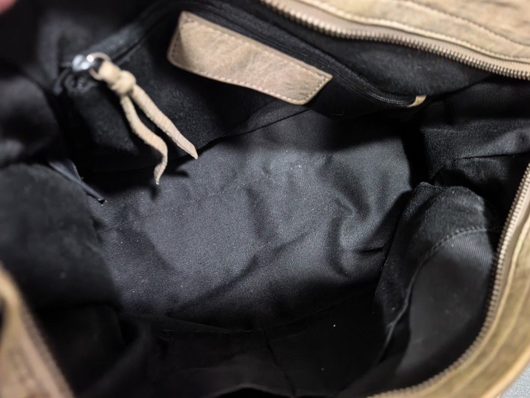 City Bag (not balenciaga) (Category: Luxury Bags & Wallets) located in Cagayan de Oro. Submitted by pootx (Listing ID 1461249259, Image 3). Description: - City bag - Color: Light beige/taupe - Material: Soft leather - Signature buckle details and fringe zipper pulls - Interior: Black fabric with one zip pocket - Includes detachable shoulder strap - Condition: Shows some signs of wear on the leather and handles.