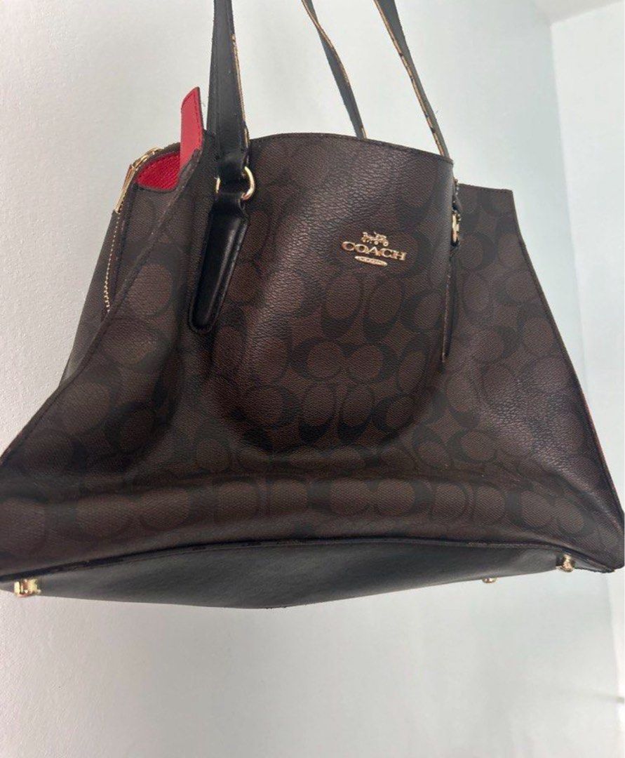 Coach bag (Category: Luxury Bags & Wallets) located in Caloocan City. Submitted by ksshboutique (Listing ID 1461123753, Image 1). Description: This bag is the Coach Tatum Carryall (specifically style C4075) crafted in Signature Coated Canvas with smooth leather details. It features a classic Brown/Black monogram pattern contrasted by a bold red fabric-lined interior and gold-tone hardware. Lowest price guarantee Declutterring .