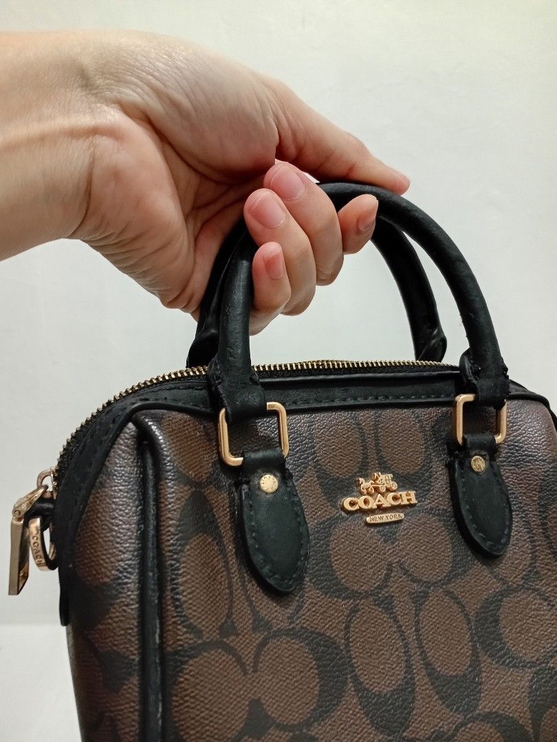 Coach Mini Rowan brown hand Bag (Category: Luxury Bags & Wallets) located in Manila. Submitted by eriiicaspage (Listing ID 1461268112, Image 1). Description: PreOwned liightly Used WellUsed Authentic Coach mini Rowan barrel hand bag - Signature monogram print (brown & black) - Gold hardware details - Zipper closure - Top handles - Small and compact, perfect for essentials - Please check photos for condition details wth Creed Sign of Used good Con
