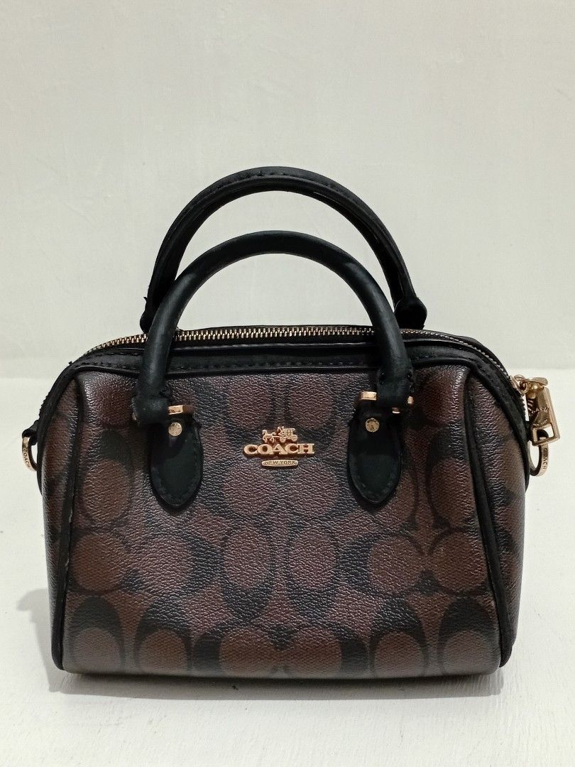 Coach Mini Rowan brown hand Bag (Category: Luxury Bags & Wallets) located in Manila. Submitted by eriiicaspage (Listing ID 1461268112, Image 3). Description: PreOwned liightly Used WellUsed Authentic Coach mini Rowan barrel hand bag - Signature monogram print (brown & black) - Gold hardware details - Zipper closure - Top handles - Small and compact, perfect for essentials - Please check photos for condition details wth Creed Sign of Used good Con