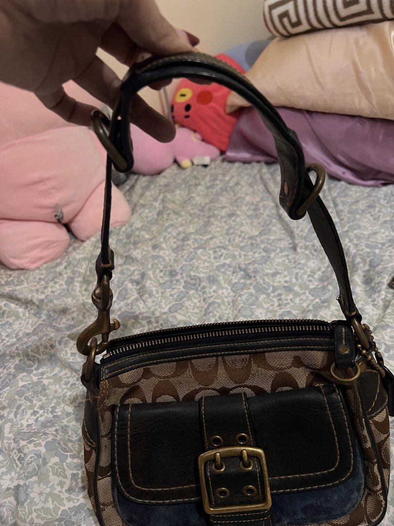 Coach Monogram Canvas Leather Trim Shoulder Bag (Category: Luxury Bags & Wallets) located in Antipolo. Submitted by ninaaisha (Listing ID 1461228679, Image 2). Description: - Authentic brown vintage Coach monogram canvas shoulder bag - Stylish black leather trim and buckle detail on front pocket - Secure zipper closure - Interior Coach leather tag with serial number - Adjustable strap with clip for comfortable wear - Compact and perfect for every