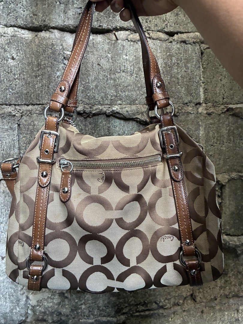 Coach Monogram Canvas Leather Trim Shoulder Bag (Category: Luxury Bags & Wallets) located in Manila. Submitted by assortedgoodsv3 (Listing ID 1461308071, Image 2). Description: - Authentic Coach bag - Classic brown and tan monogram pattern - Genuine leather trim and handles - Luxurious purple satin interior lining - Zippered main compartment for security - Interior zip pocket for organization - Comes with original Coach hang tag - Ideal everyday 