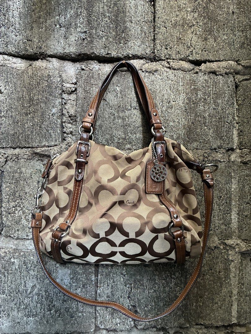 Coach Monogram Canvas Leather Trim Shoulder Bag (Category: Luxury Bags & Wallets) located in Manila. Submitted by assortedgoodsv3 (Listing ID 1461308071, Image 1). Description: - Authentic Coach bag - Classic brown and tan monogram pattern - Genuine leather trim and handles - Luxurious purple satin interior lining - Zippered main compartment for security - Interior zip pocket for organization - Comes with original Coach hang tag - Ideal everyday 