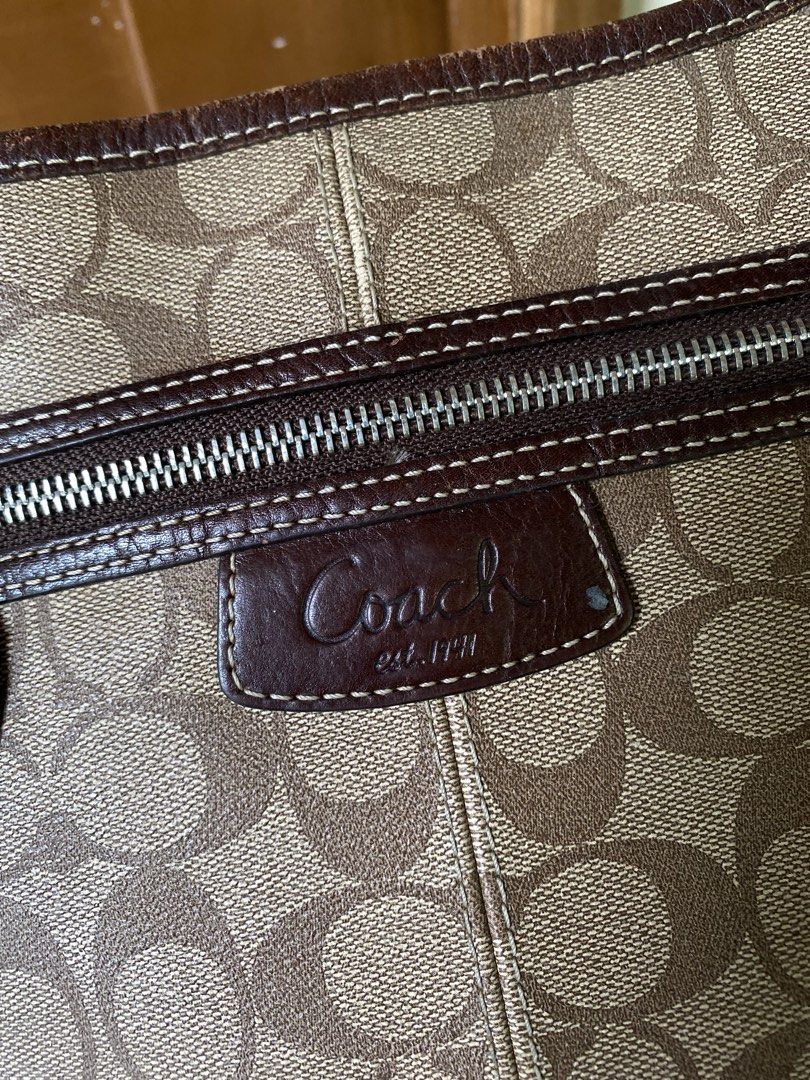 Coach Monogram Canvas Shoulder Bag (Category: Luxury Bags & Wallets) located in Lucena. Submitted by handpickthrift (Listing ID 1461248855, Image 3). Description: - Classic Coach shoulder bag in signature monogram canvas. - Features brown leather trim and strap. - Secure zipper closure. - Bright yellow interior lining. - Adjustable strap for comfortable wear. - Ideal everyday bag with plenty of interior space..