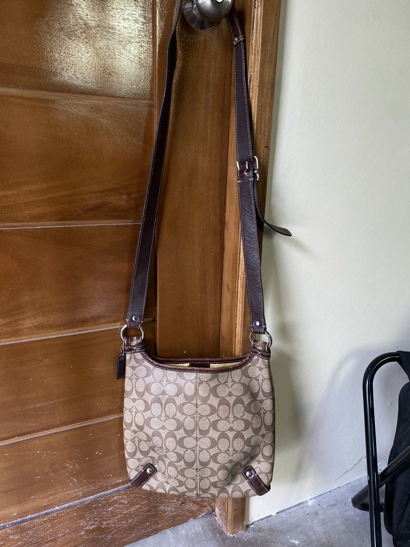Coach Monogram Canvas Shoulder Bag (Category: Luxury Bags & Wallets) located in Lucena. Submitted by handpickthrift (Listing ID 1461248855, Image 2). Description: - Classic Coach shoulder bag in signature monogram canvas. - Features brown leather trim and strap. - Secure zipper closure. - Bright yellow interior lining. - Adjustable strap for comfortable wear. - Ideal everyday bag with plenty of interior space..
