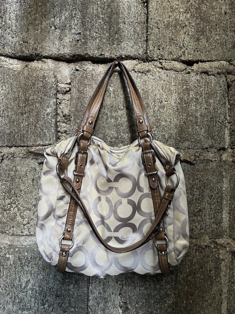 Coach Signature C Monogram Shoulder Bag (Category: Luxury Bags & Wallets) located in Manila. Submitted by assortedgoodsv3 (Listing ID 1461307985, Image 1). Description: - Coach shoulder bag - Signature C monogram pattern - Tan and brown colorway - Genuine leather trim and straps - Secure zipper closure - Interior zippered pocket - Interior slip pocket - Minor stains on interior lining - Ideal for everyday use.