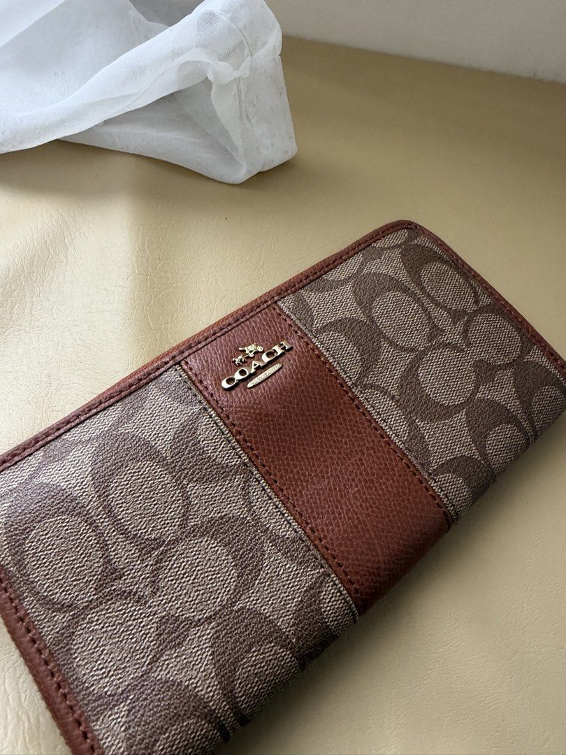 Coach Signature Zip Around Wallet (Category: Wallets & Card holders) located in Alfonso. Submitted by jbcamet (Listing ID 1461156891, Image 2). Description: - Coach Zip Around Wallet - Signature Print (Brown & Tan) - Multiple Card Slots & Compartments - Secure Zipper Closure - Gold-Tone Hardware with Coach Logo Zipper Pull - Ideal for Organizing Essentials.