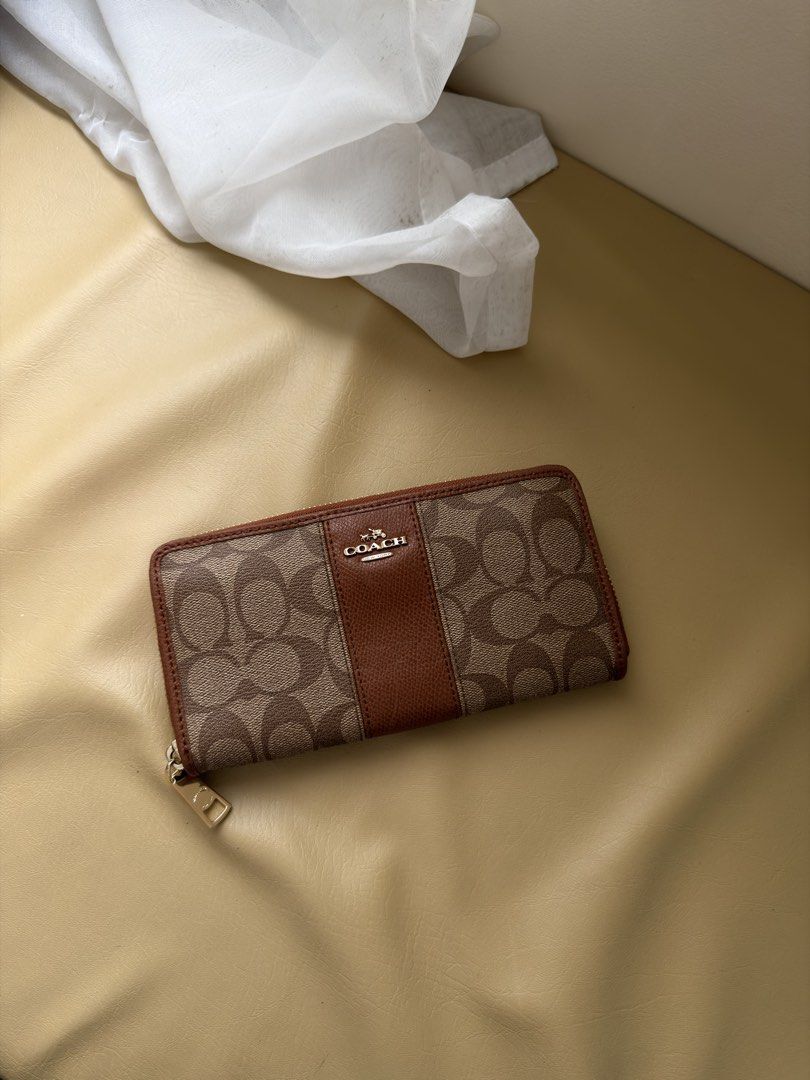 Coach Signature Zip Around Wallet (Category: Wallets & Card holders) located in Alfonso. Submitted by jbcamet (Listing ID 1461156891, Image 1). Description: - Coach Zip Around Wallet - Signature Print (Brown & Tan) - Multiple Card Slots & Compartments - Secure Zipper Closure - Gold-Tone Hardware with Coach Logo Zipper Pull - Ideal for Organizing Essentials.