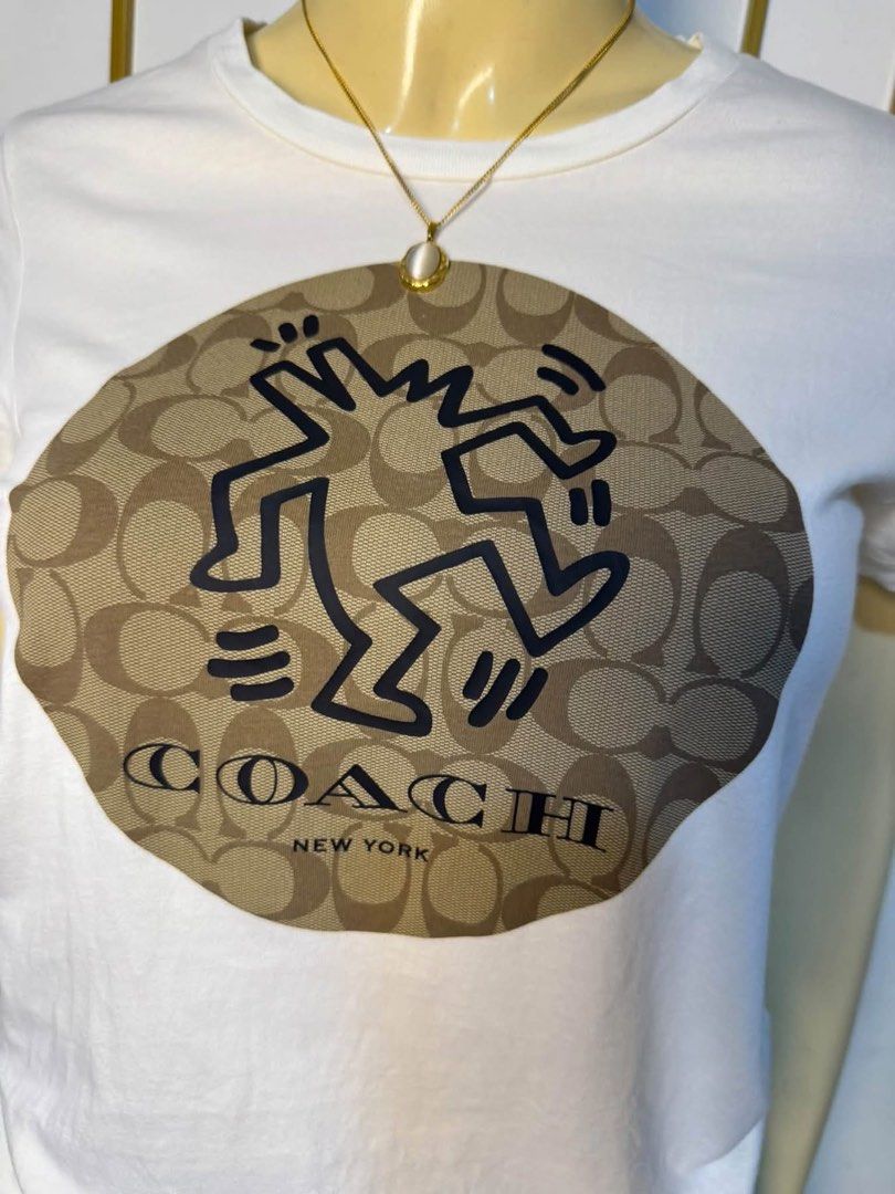 Coach x Keith Haring White T-Shirt (Category: Tshirts & Polo Shirts ) located in Pasacao. Submitted by wengpullar37205 (Listing ID 1461269986, Image 3). Description: - Authentic White Coach T-Shirt - Features iconic Keith Haring dancing figure graphic - Includes Coach New York logo - Made from 100% premium cotton - Tagged size XS - Ideal for everyday casual wear.