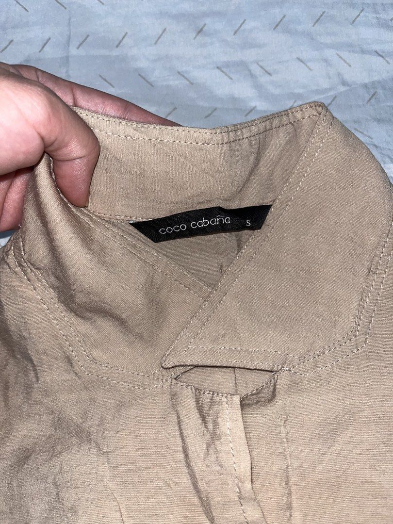 ST22 Coco Cabana Beige Cropped Tie Front Shirt (Category: Shirts) located in Marikina City. Submitted by namicorner (Listing ID 1461267981, Image 2). Description: - Brand: Coco Cabana - Style: Cropped Shirt - Color: Beige - Neckline: Collared - Sleeves: Short sleeves - Closure: Button-down front - Features: Tie detail at the bottom ~~ > RFS - decluttering > Last price posted > NO RETURN/ NO EXCHANGE > Manage expectation as this is a preloved item