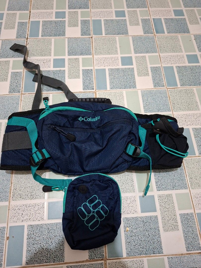 Columbia Navy Blue Hiking Backpack with Pouch (Category: Backpacks) located in Lapu Lapu. Submitted by margaux099 (Listing ID 1461303573, Image 1). Description: - Navy blue Columbia - Teal accents throughout - Detachable front pouch included - Adjustable straps for comfortable wear - Spacious interior for essentials - Zippers in excellent working condition - Ideal for hiking and day trips.