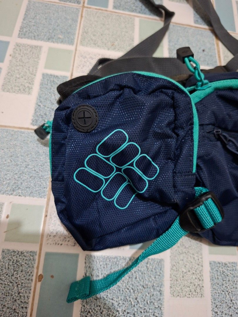 Columbia Navy Blue Hiking Backpack with Pouch (Category: Backpacks) located in Lapu Lapu. Submitted by margaux099 (Listing ID 1461303573, Image 3). Description: - Navy blue Columbia - Teal accents throughout - Detachable front pouch included - Adjustable straps for comfortable wear - Spacious interior for essentials - Zippers in excellent working condition - Ideal for hiking and day trips.