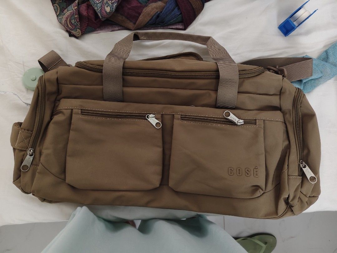 COSE Brown Duffle Bag with Multiple Pockets (Category: Cross-body Bags) located in Quezon City. Submitted by claudinen70390 (Listing ID 1461138169, Image 1). Description: - Brand: COSE - Color: Brown - Pockets: Two front zip pockets, two side zip pockets - Main Compartment: Double zipper closure - Strap: Adjustable shoulder strap included - Ideal for: Travel, gym.