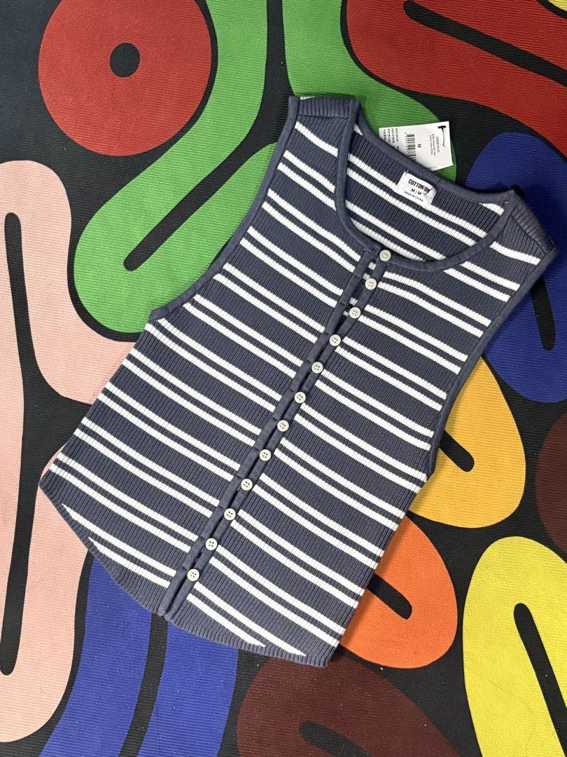 Cotton On Navy Stripe Button Down Rib Vest M (Category: Sleeveless) located in Orani. Submitted by leannejoyful (Listing ID 1461285834, Image 2). Description: - Navy and white striped ribbed vest - Brand: Cotton On - Button-down front - Sleeveless design - Versatile: great for layering or wearing on its own - Pairs perfectly with jeans - Size: Medium (M).