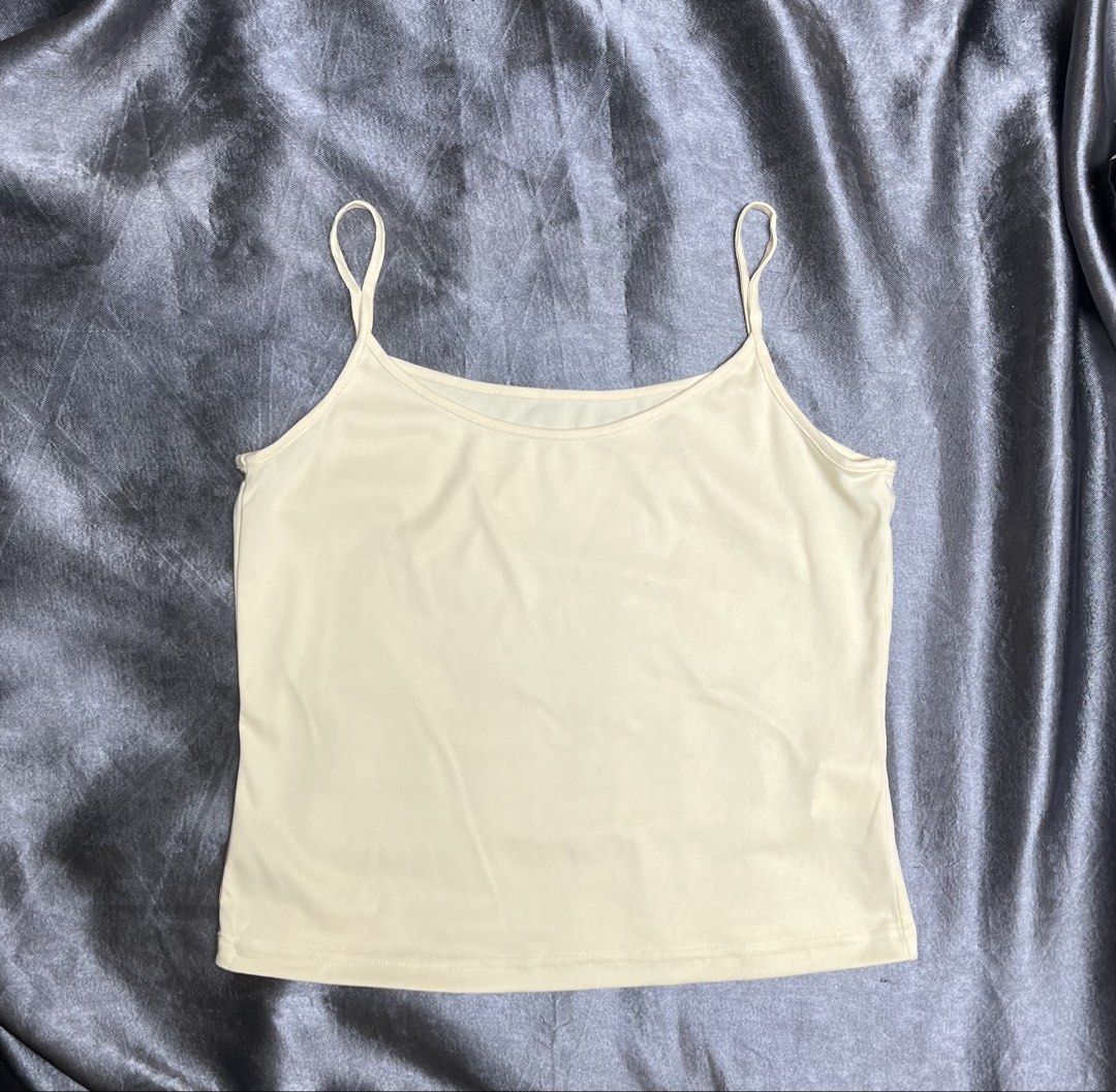 Cream Camisole Tank Top Spaghetti Straps (Category: Sleeveless) located in Cavite. Submitted by bellewii (Listing ID 1461224942, Image 1). Description: - Simple cream camisole - Thin spaghetti straps - Stretchy material for comfort - Versatile: great for layering or wearing on its own - Essential basic piece for any wardrobe - Fits true to size.