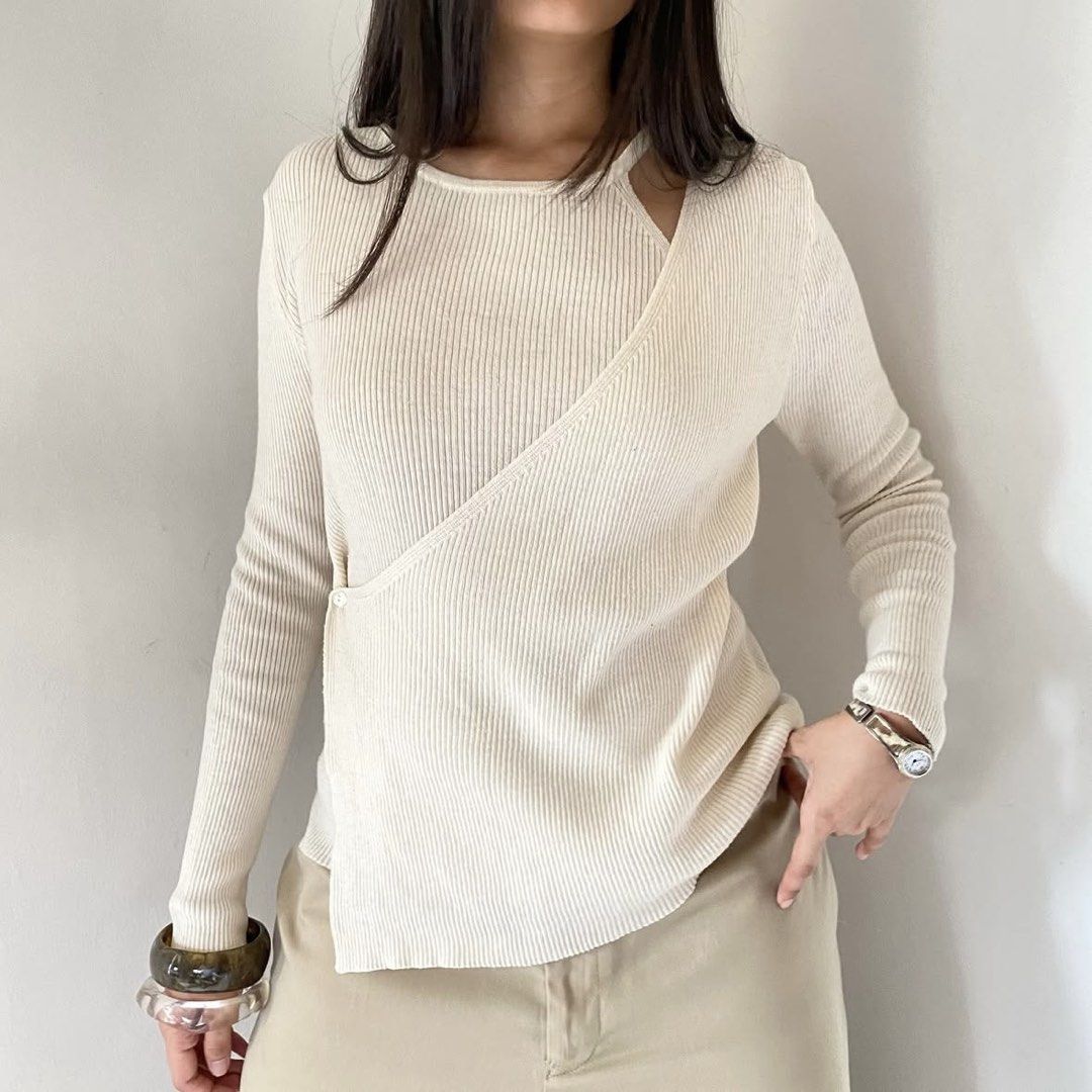 Cream Ribbed Overlap Layered Wrap Long Sleeves Top (Category: Longsleeves) located in Quezon City. Submitted by danalou (Listing ID 1461222542, Image 1). Description: - S-M - Bust can fit until 38", Length 24" - halter cut inner, with button - bought from vintheline on ig.