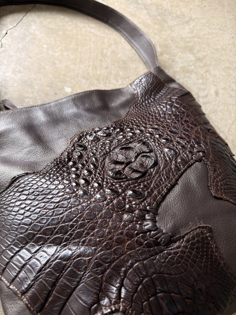 Custom Leather Shoulder Bag with Crocodile Embossing (Category: Shoulder Bags) located in Alfonso. Submitted by jbcamet (Listing ID 1461282423, Image 2). Description: - Dark brown leather shoulder bag - Unique patchwork design - Crocodile-embossed leather accents - Adjustable strap with buckle - Zippered pocket on the back - Spacious interior - Ideal for everyday use.