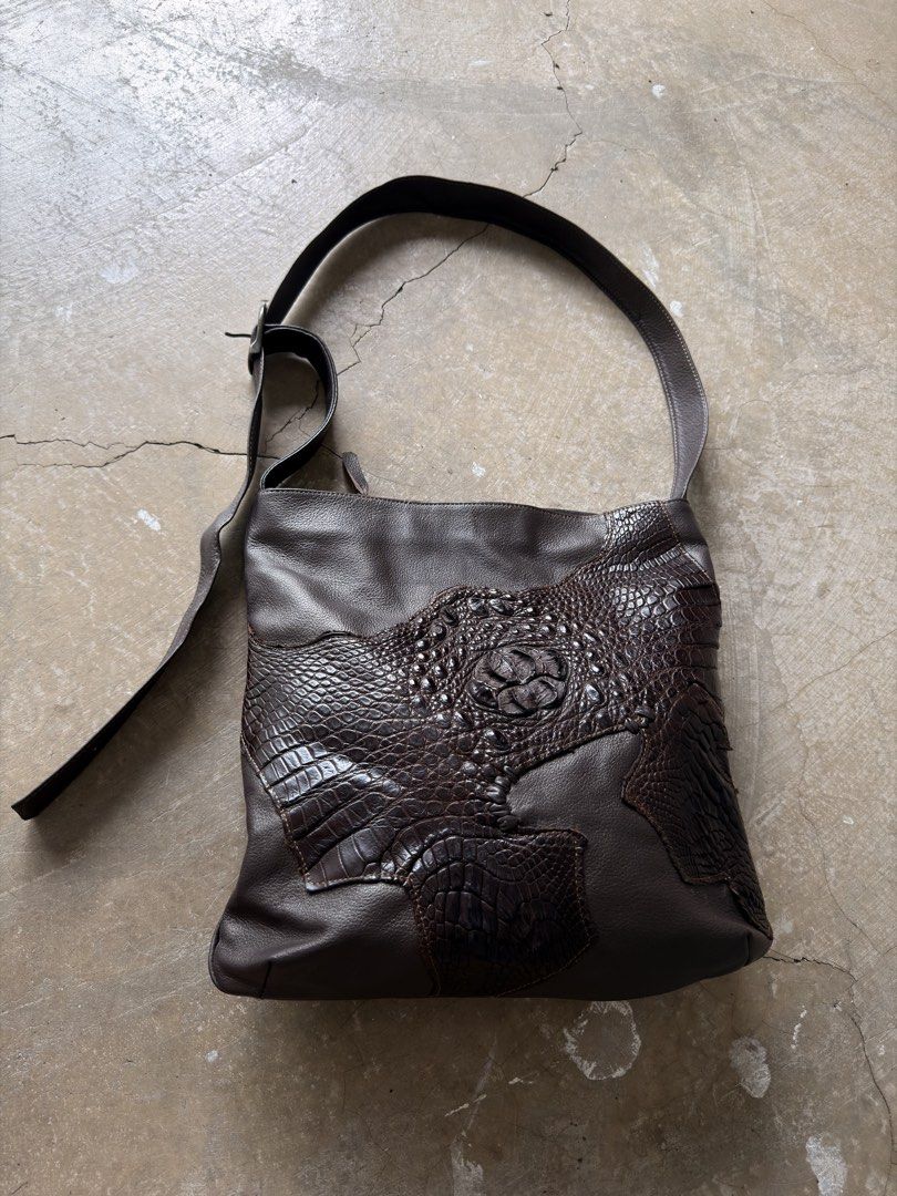 Custom Leather Shoulder Bag with Crocodile Embossing (Category: Shoulder Bags) located in Alfonso. Submitted by jbcamet (Listing ID 1461282423, Image 1). Description: - Dark brown leather shoulder bag - Unique patchwork design - Crocodile-embossed leather accents - Adjustable strap with buckle - Zippered pocket on the back - Spacious interior - Ideal for everyday use.